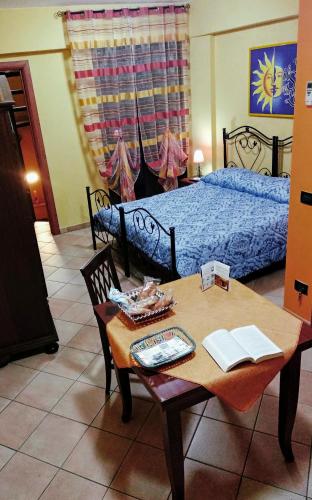 a bedroom with a bed and a table with a blue bed at Il Sole e La Luna in Agrigento