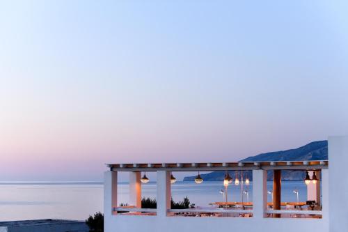 a view of the ocean from a hotel with lights at Skyros Ammos Hotel in Skiros