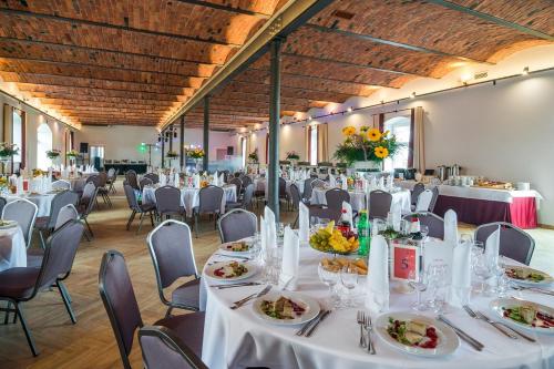 a banquet hall with white tables and chairs at Hotel Karczyce in Karczyce
