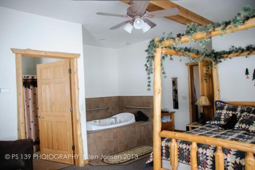 a bedroom with a bed and a ceiling fan at Second Wind Country Inn in Ashland