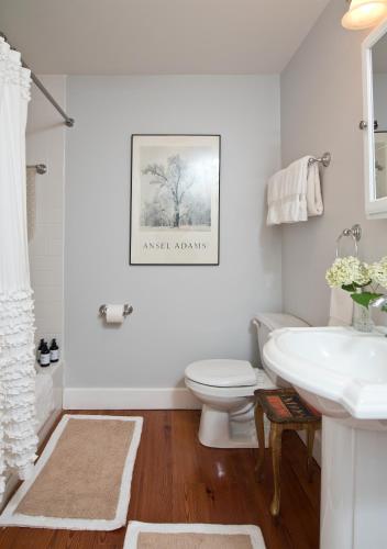 a white bathroom with a sink and a toilet at Hudson B&B in Hudson
