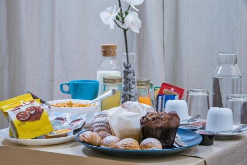 a table with a plate of pastries and other food at B&B del Sole in Ercolano
