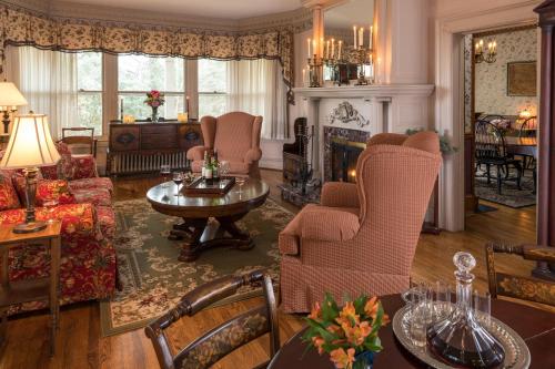 a living room filled with furniture and a fireplace at The Yellow House on Plott Creek in Waynesville