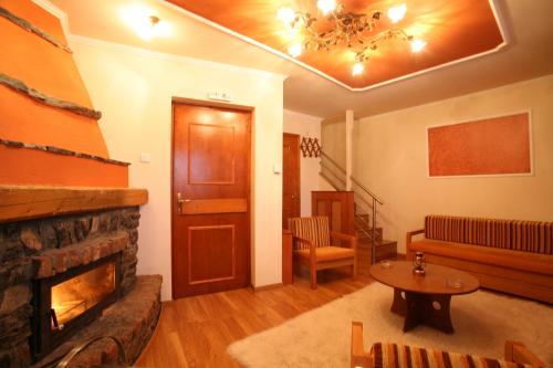 a living room with a fireplace and a couch at Exohiko in Palaios Agios Athanasios