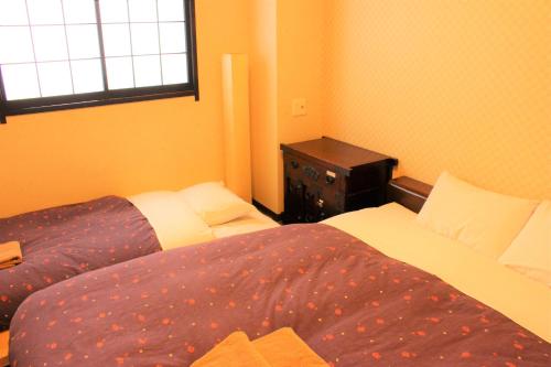 Ένα ή περισσότερα κρεβάτια σε δωμάτιο στο K's House Tokyo Oasis - Quality Hostel in Asakusa