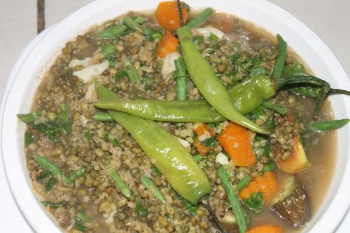 a bowl of soup with peas and vegetables in it at Deep Forest Garden Hotel in Puerto Princesa City