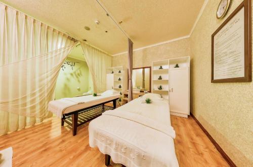 a room with two beds and a desk in it at Sea Links Beach Hotel in Mui Ne