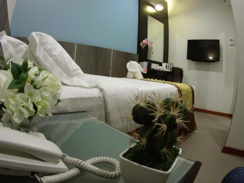 a hospital room with a bed and a table with a phone at Meriton Inn in Kuantan