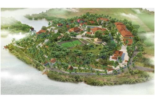 an island in the water with a house and a tennis court at Mercure Goa Devaaya Resort in Old Goa