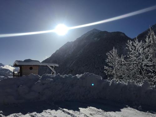 a pile of snow in front of a mountain at Ferienhof Oberer Gollmitzer in Heiligenblut