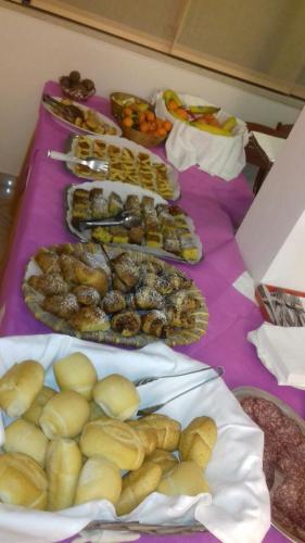 a table topped with lots of different types of food at Hotel Marylise in Rimini