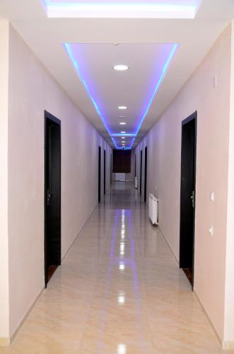 an empty hallway with a blue light on the ceiling at KavKaz Hotel & Restaurant in Marneuli