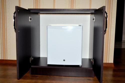 a tv screen in a black and white case at KavKaz Hotel & Restaurant in Marneuli