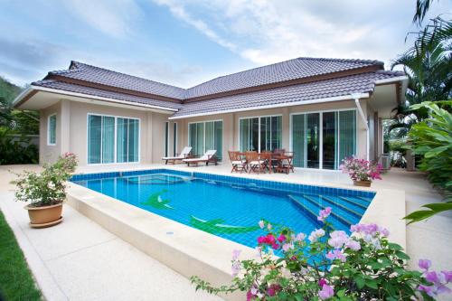 a house with a swimming pool in the backyard at Villa with private pool in Hua Hin