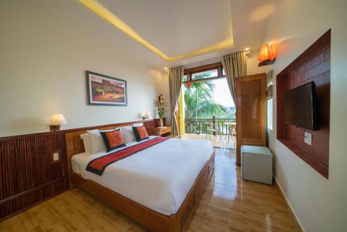 a bedroom with a large bed and a television at Lakeview Villa Homestay in Hoi An