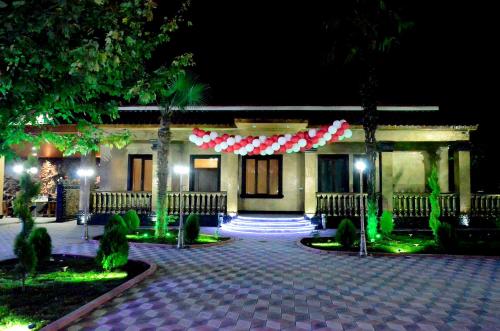 a building with a red and white banner on it at KavKaz Hotel & Restaurant in Marneuli