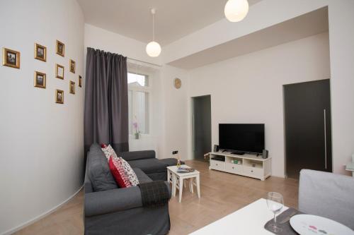 a living room with a couch and a tv at Luxury apartment Spálená in Prague