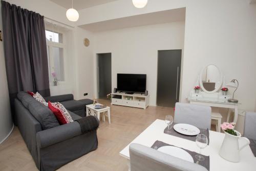 a living room with a couch and a table at Luxury apartment Spálená in Prague