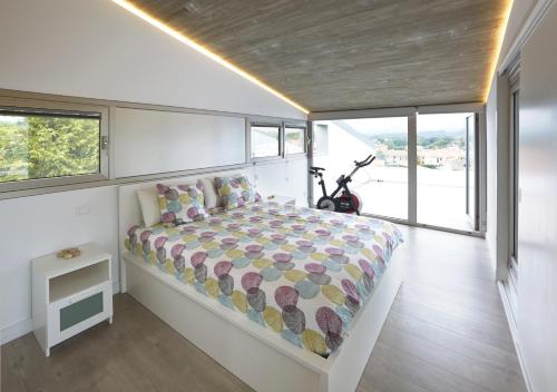 a bedroom with a bed in a room with windows at La casa de Marta in Celorio