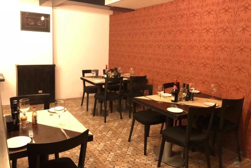 a dining room with tables and chairs with wine glasses at Hotel Sommelier Boutique in Santiago