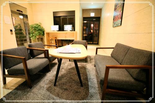 a waiting room with two chairs and a table at TRT Hotel in Busan