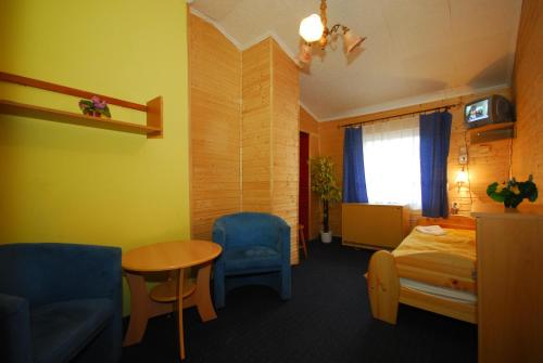 a hotel room with a bed and a table at Western Penzion in Ružomberok