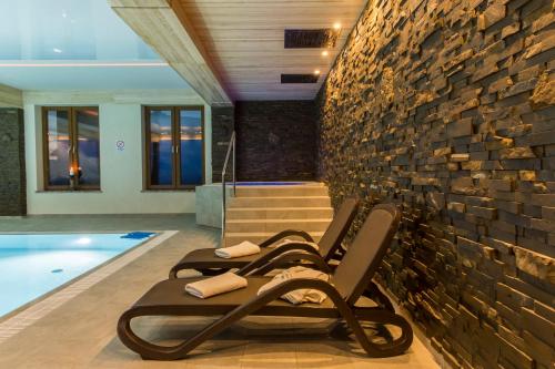 a row of lounge chairs next to a swimming pool at Giewont in Murzasichle