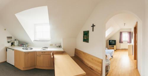 a kitchen with a sink and a cross on the wall at Gästezimmer Sengstschmid in Windhaag bei Freistadt