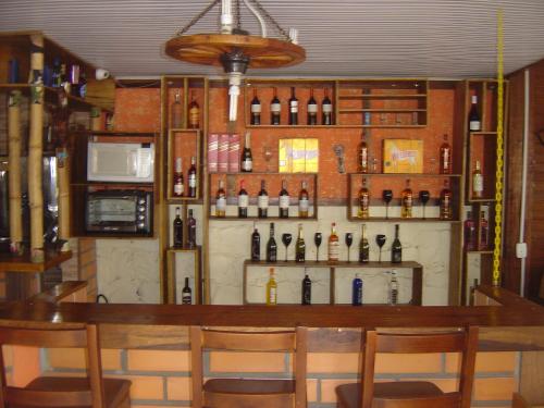 a bar with bottles of wine on a wall at Hotel Pousada Casa Nostra in Erechim