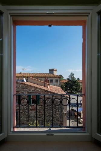 a window with a view of a building at Hotel Aganoor in Castiglione del Lago