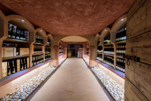 a wine cellar with rows of wine bottles at Hotel Maso del Brenta in Caderzone