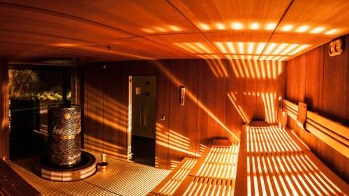 a room with a bench with lights on it at La Casies Mountain Hotel in Santa Maddalena in Casies