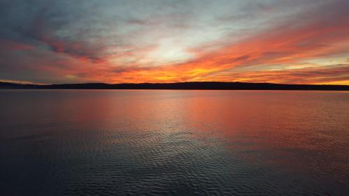 a sunset over a large body of water at Apartments Adriatic in Selce