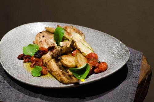 a plate of food with meat and vegetables on a table at Summerfields Rose Retreat and Spa in Hazyview