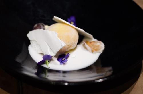 a plate with ice cream and purple flowers on it at Summerfields Rose Retreat and Spa in Hazyview