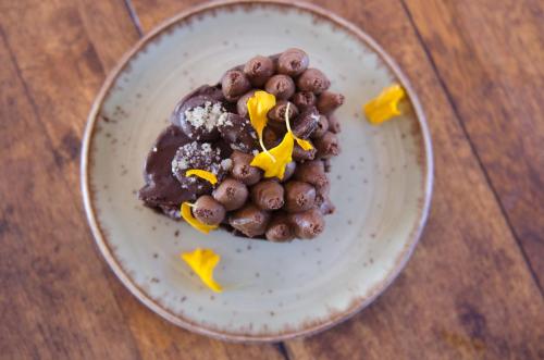 a plate of food on a wooden table at Summerfields Rose Retreat and Spa in Hazyview
