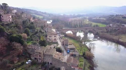 a view of a town with a bridge over a river at Locanda del Borgo in Todi