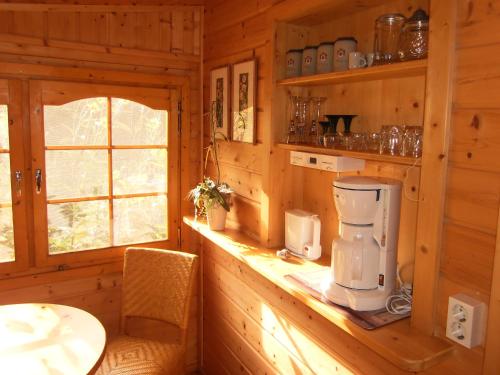 a kitchen with a counter in a wooden cabin at Ferienhütte Stephanie in Niederschlettenbach