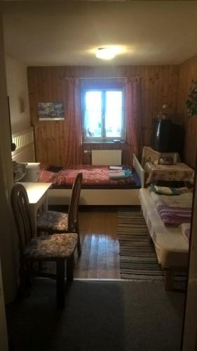 a bedroom with a large bed and a table and chairs at Haus Tulpe in Strobl