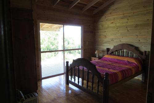a bedroom with a bed and a large window at Playa Grande Frente al Mar in San Clemente del Tuyú