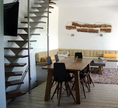 a dining room with a wooden table and chairs at Manna Gea in Vonitsa
