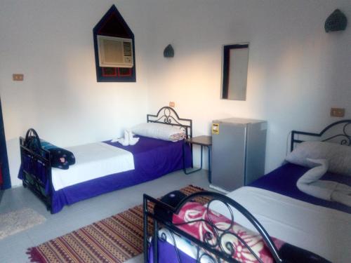 מיטה או מיטות בחדר ב-Monica Hotel