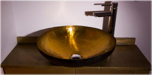 a wooden bowl sink with a faucet in a bathroom at Parco d'Arte AltArt in Rende