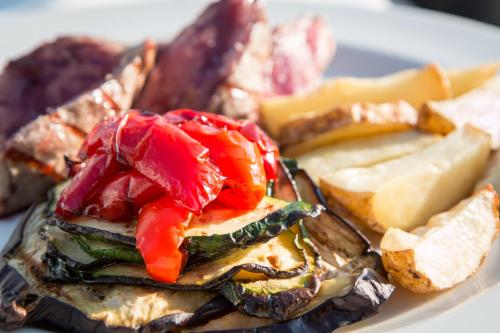 a plate of food with different types of bread and cheese at Hotel Sole in Cannero Riviera