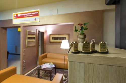a hotel room with a lobby with a waiting area at La Piana Hotel in Tito