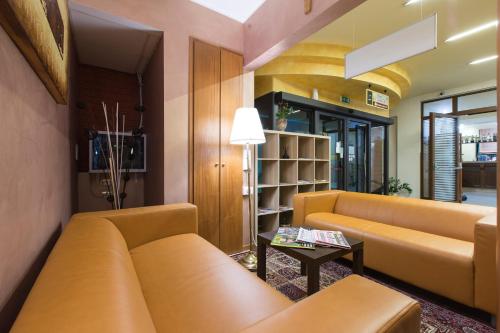 a living room with a couch and a table at La Piana Hotel in Tito