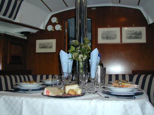 a table with plates of food and flowers on it at La Casa di Ulisse B&B in Quercianella