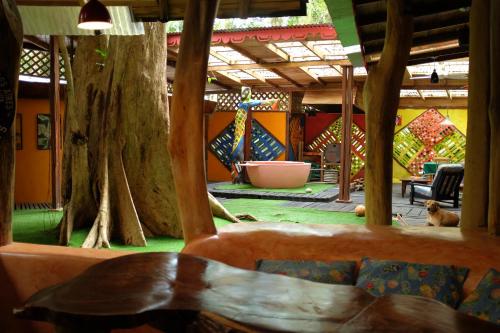 a room with a couch and a table and trees at Tree House Beachfront Lodge in Puerto Viejo