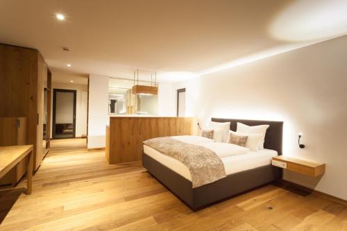 a bedroom with a large bed in a room at Weinvilla Vollmayer in Hilzingen