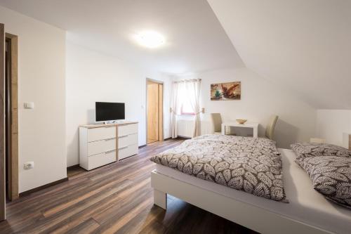 A bed or beds in a room at Apartments Planina pod Sumikom